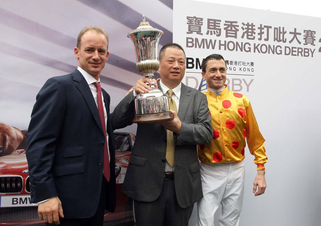 Left to right: Richard Gibson, Pan Sutong, and jockey Douglas Whyte after winning the 2013 Hong Kong Derby with Akeed Mofeed. Photo: HKJC