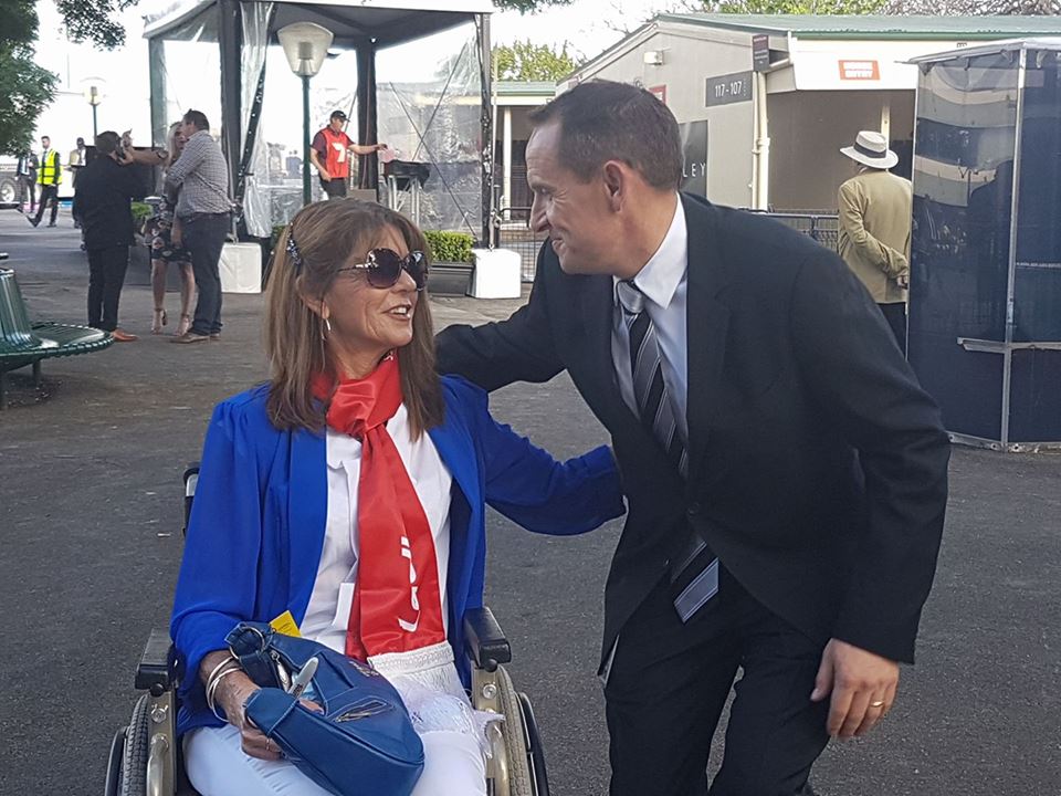 “I am the luckiest person on course today.” Carolyn Nutt with Winx’s trainer, Chris Waller, at Moonee Valley on Saturday. Photo: Kristen Manning