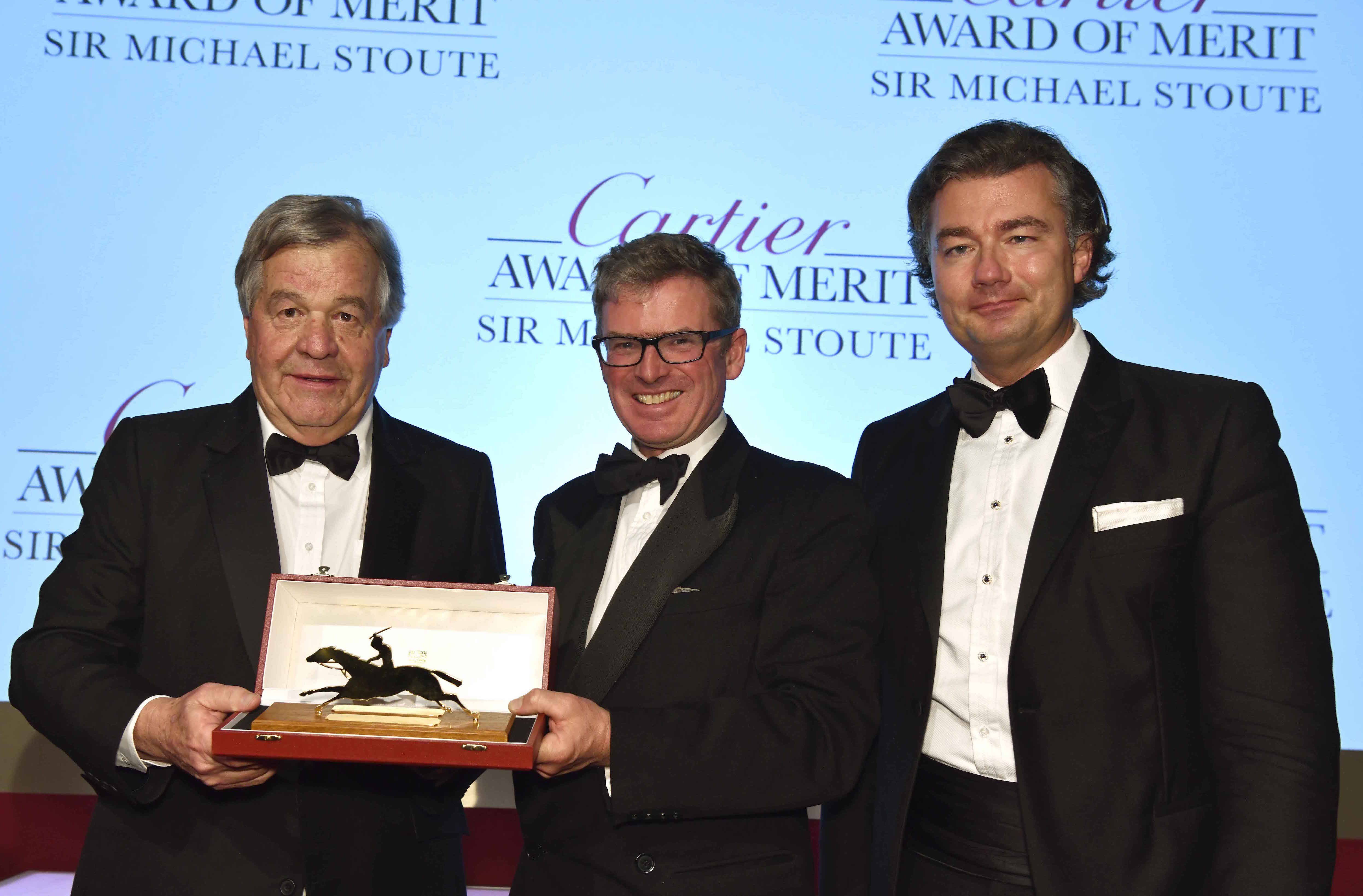 Stoute receives the Merit Award from Daily Telegraph racing writer Marcus Armytage (centre) and Cartier managing director Laurent Feniou. Photo: Tim Griffiths