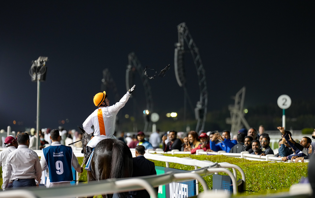 Crowd pleaser: Tadhg O’Shea throws his goggles to fans after one of his many Meydan successes. Photo: Dubai Racing Club