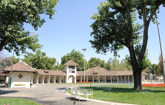 The paddock, with Mission Revival-style saddling stalls. Photo via Isabelle Taylor