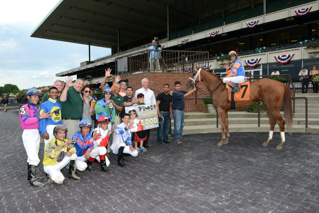 New York jockeys join John Velazquez on Galloping Giraffe in the winner's circle at Belmont Park after his 5,000th win. Photo: NYRA/Adam Coglianese.