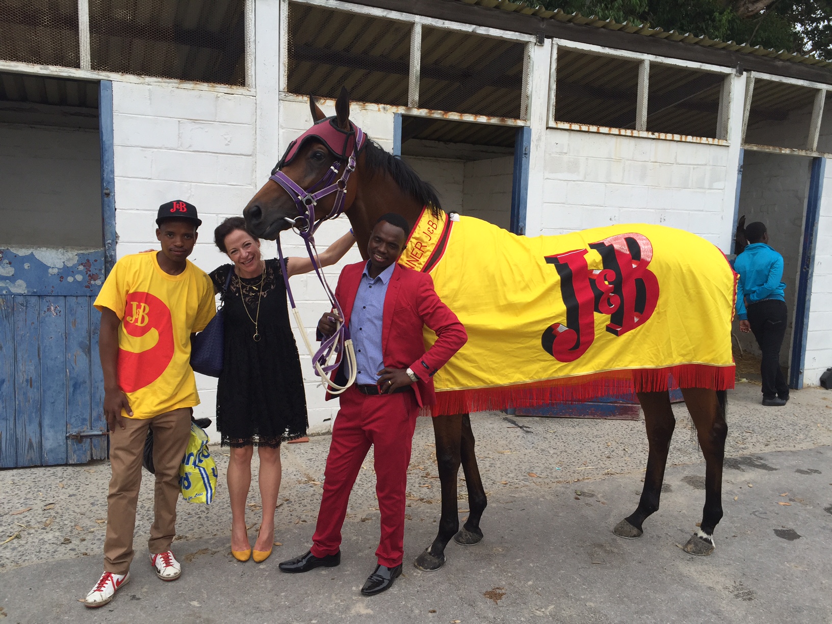 Smart team: Bangeli Mngeni (red suit), Jessica Slack and groom Akona Mqanda with Smart Call after her J&B Met victory. Photo: Mauritzfontein Stud