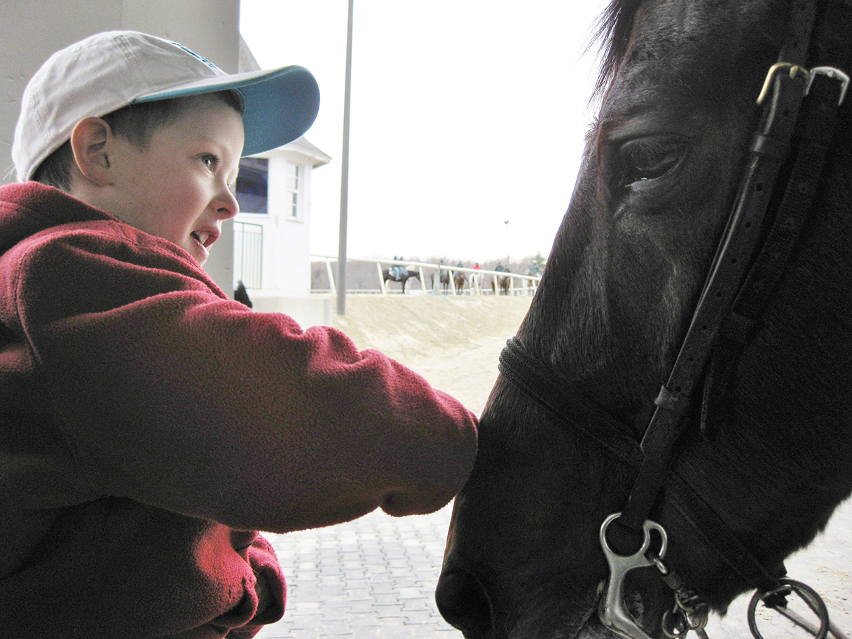 The next generation of racing fan gets his first close up with a patient pony at Laurel Park in 2015. Photo: Mary Curran