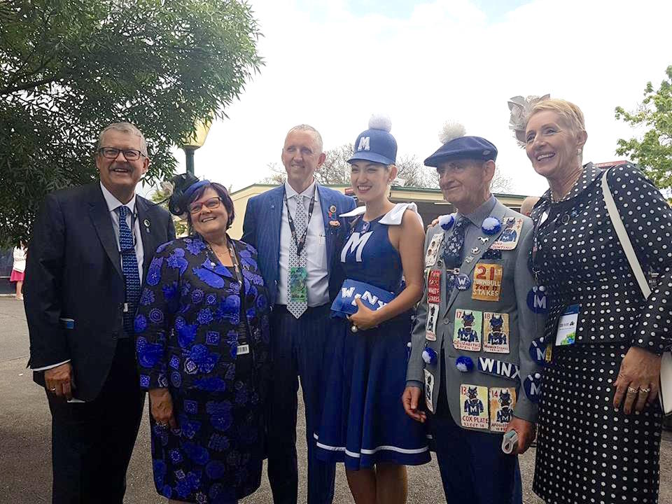 Homage to a great: Lloyd Menz (second right) alongside his daughter, Angela, poses for pictures with Winx’s owners before the race. Photo: Kristen Manning