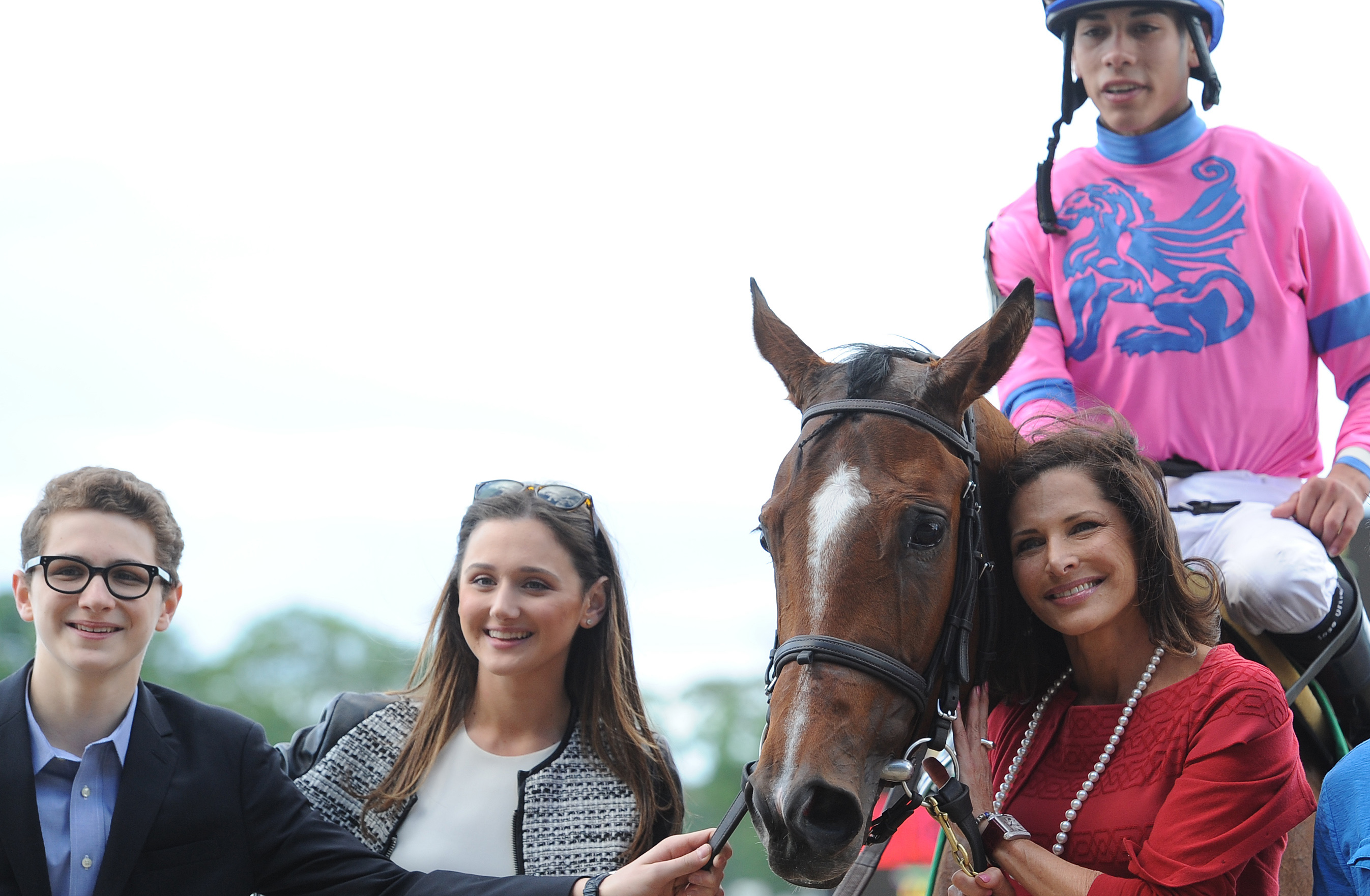 True love: Sheila Rosenblum (red dress), son Erik (left), and daughter Kara with La Verdad (Jose Ortiz) after winning at Belmont Park in 2014. Photo: NYRA/Susie Raisher