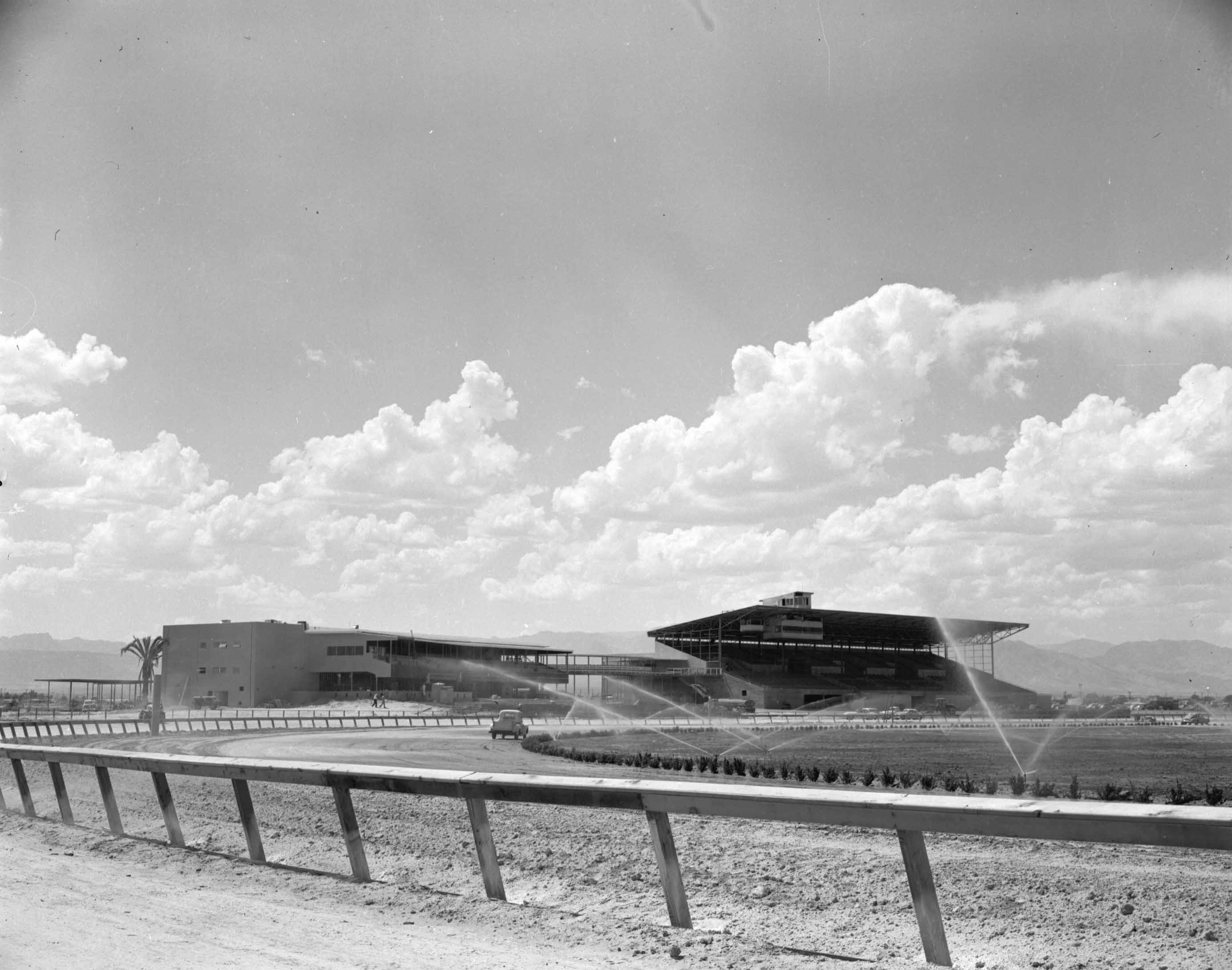 The Las Vegas track during construction in 1951. The clubhouse and grandstands appear largely complete, but the inside rail has not been installed. The turf course, which was never used, is being watered. Photo: Las Vegas News Bureau