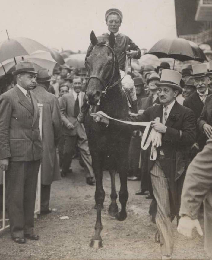 Pharis and Charlie Elliott being led in by Marcel Boussac after winning the Prix du Jockey Club in 1939