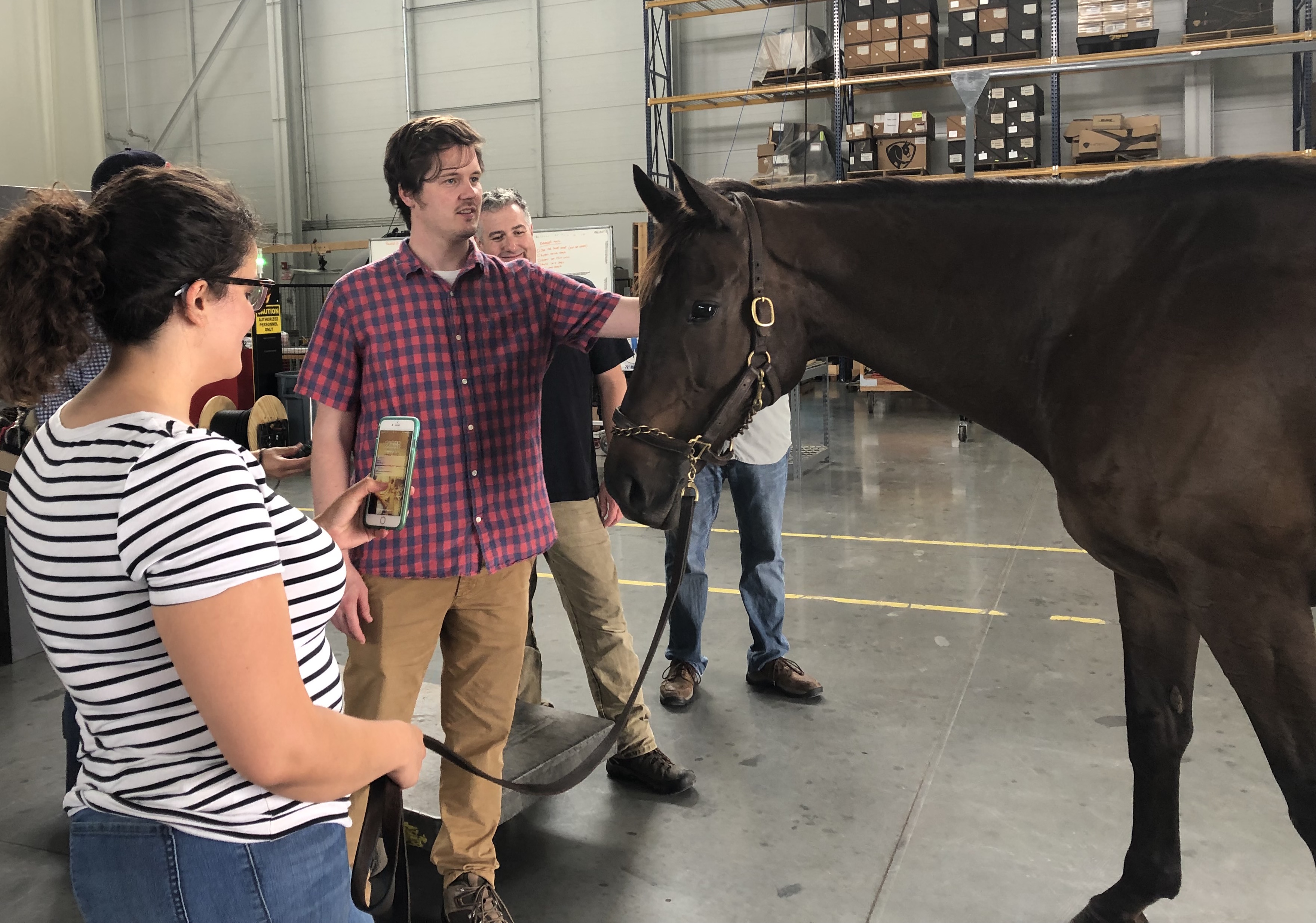 New friends: “A lot of the production crew had never been around horses,” says Carleigh Fedorka. “At first, they were petrified of Nixon, but by the end they got a group picture with him and were excited.” Photo: Carleigh Fedorka
