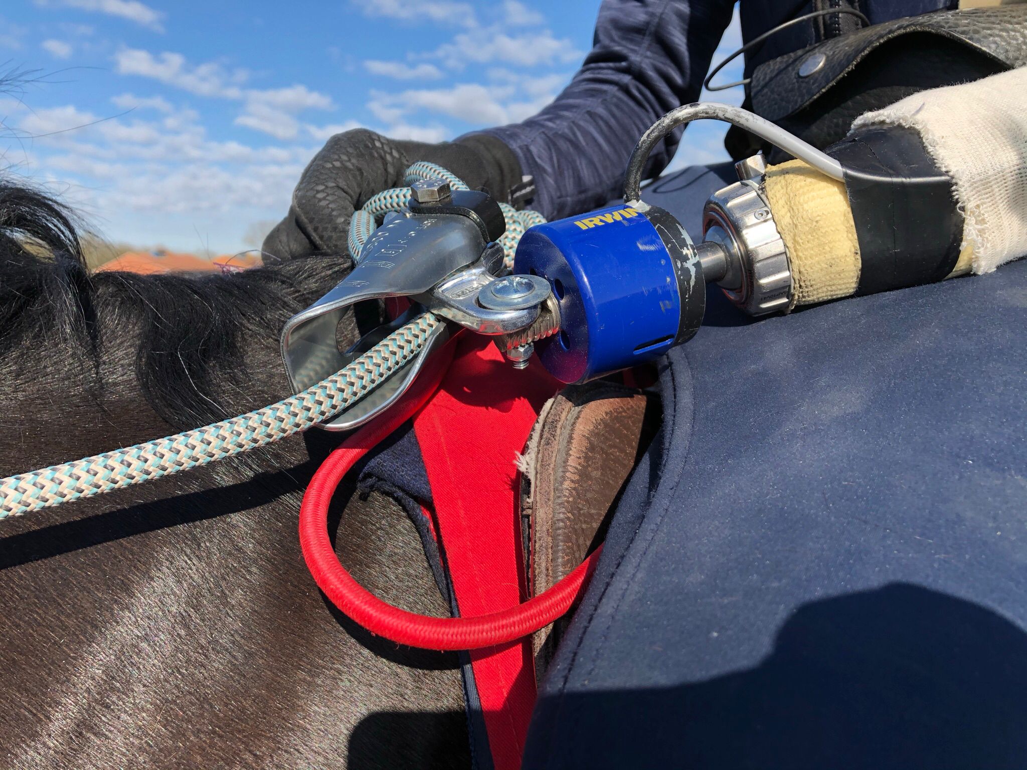 Harry Enright’s prosthetic arm with the device attached to the reins. If he falls off, the plug is pulled out of the battery and it releases instantaneously. Photo: British Racing School