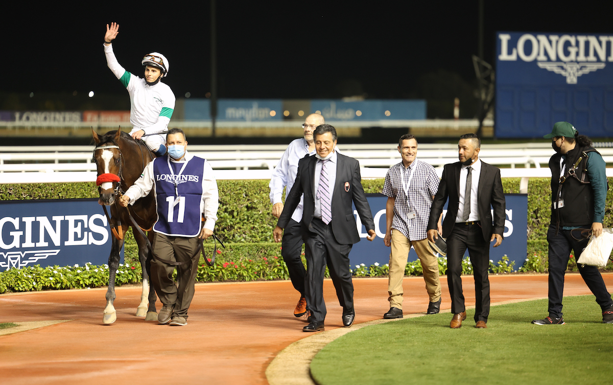 Team player: Leandro Mora (centre) with the Hot Rod Charlie team as William Buick acknowledges the crowd after victory in Round 2 of the Maktoum Challenge. Photo: Dubai Racing Club
