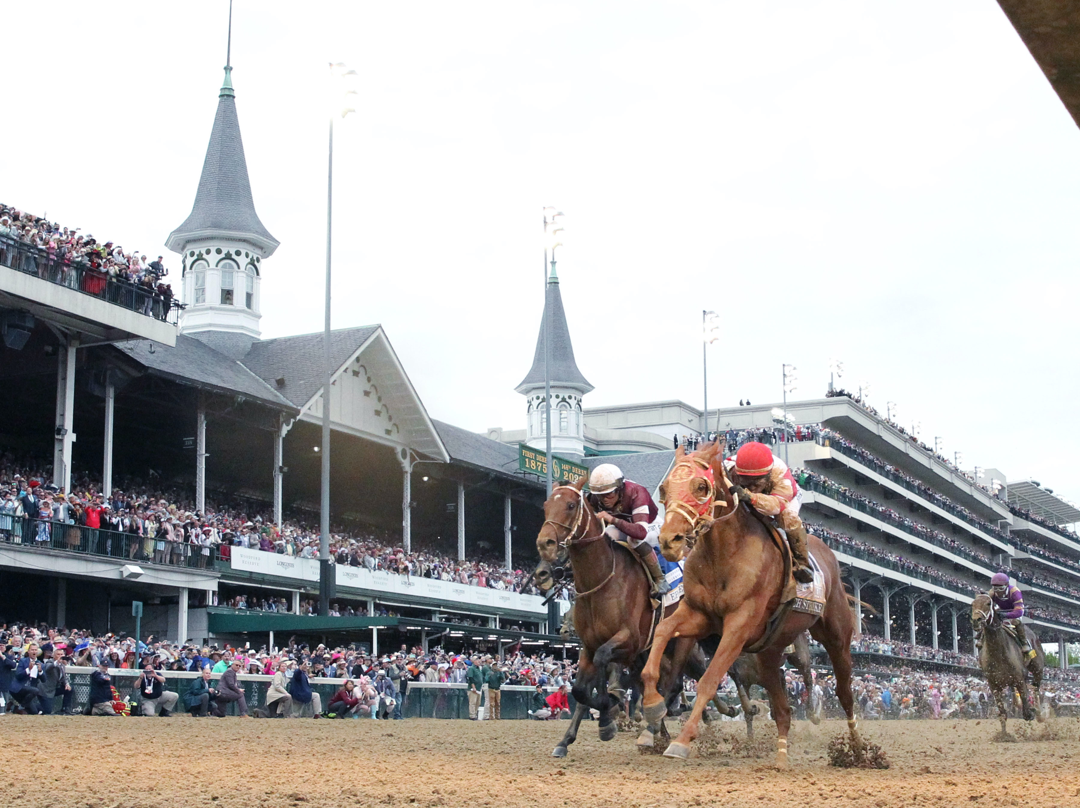 Rich Strike (Sonny Leon, right) moves past favourite Epicenter to record a huge Kentucky Derby upset beneath the Twin Spires. Photo: Churchill Downs/Coady
