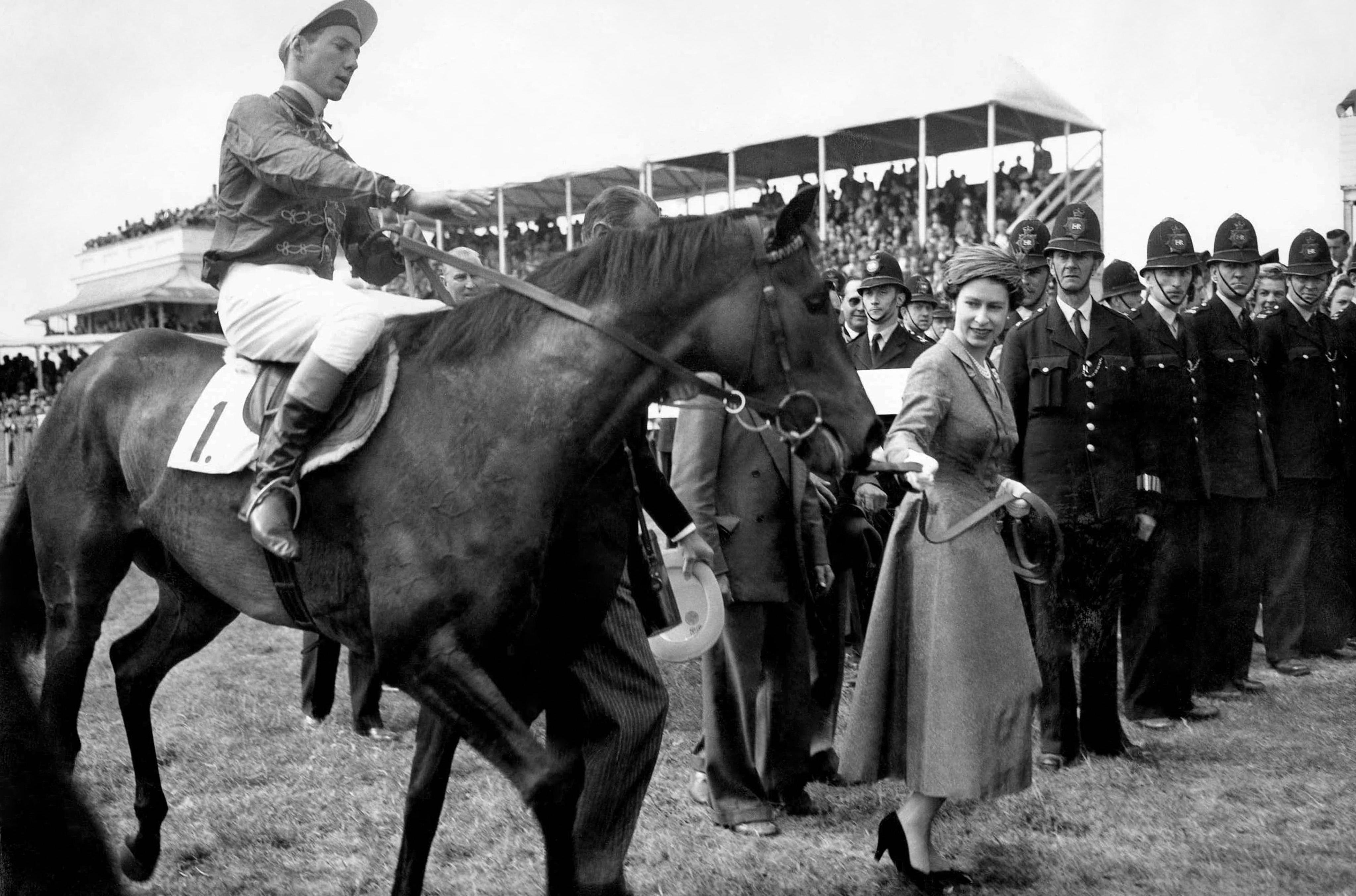 The monarch and the Maestro: the Queen leads in her first Classic winner, the Lester Piggott-ridden Carrozza, after the 1957 Oaks. Photo: Alamy/Great British Racing