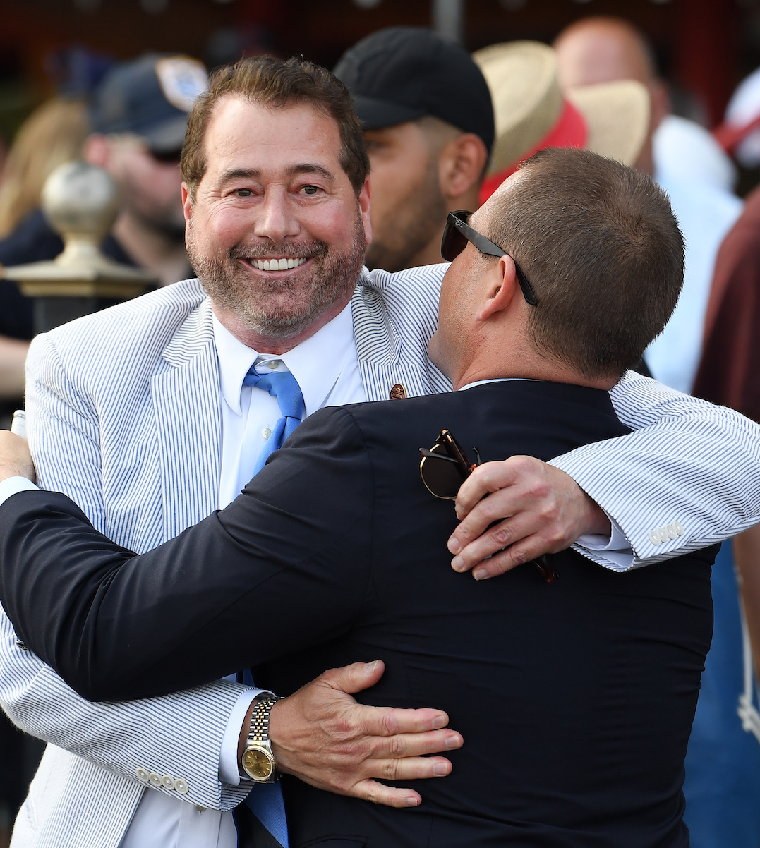 Let’s hug it out: John Hendrickson embraces trainer Norm Casse after a win for Marylou Whitney Stables at Saratoga. Photo: NYRA / Susie Raisher (Coglianese)