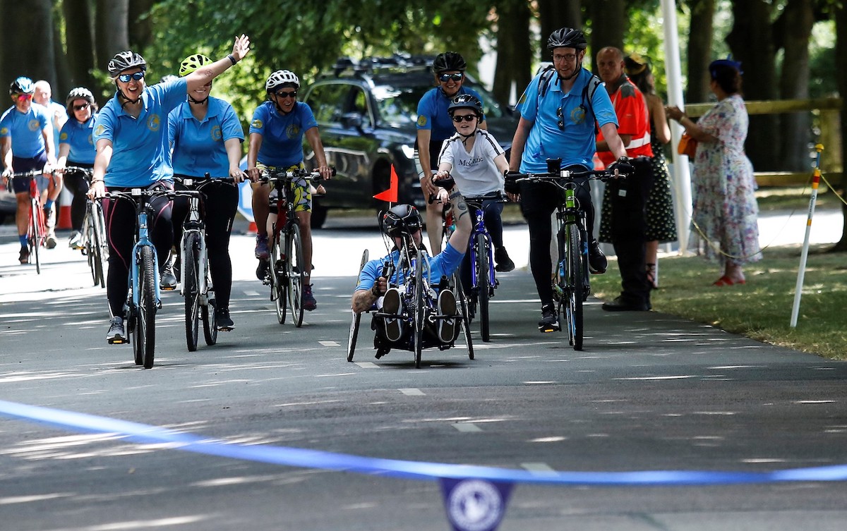 Not far to go: Jacob Pritchard Webb and his support team approach the finishing line. Photo: Jockey Club