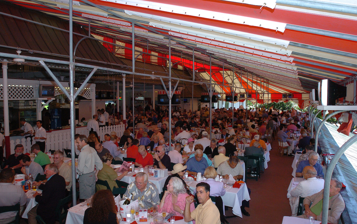 Candy-striped crowd: enjoying a typical Saratoga dining scene underneath the red and white awnings. Photo: NYRA / Coglianese