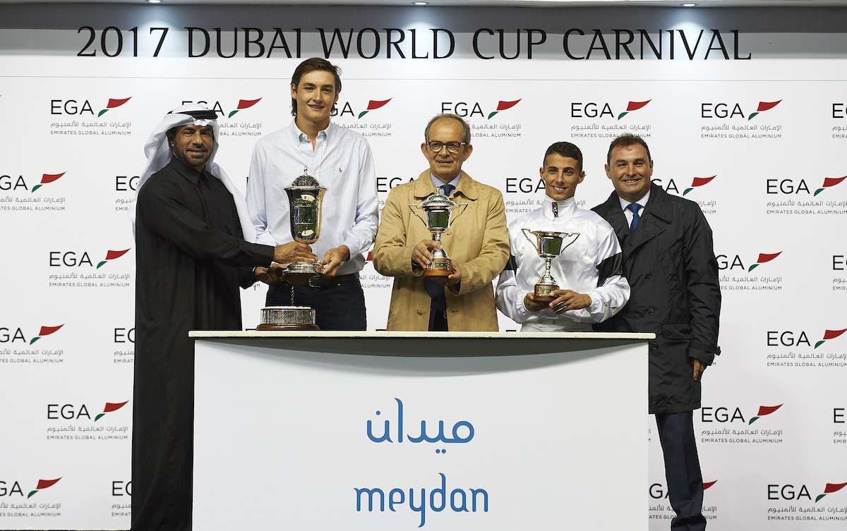 Erwan Charpy (centre, beige coat) at the Meydan trophy presentation after Furia Cruzada’s victory in the Maktoum Challenge Round 2 in February 2017. Photo: Dubai Racing Club / Andrew Watkins