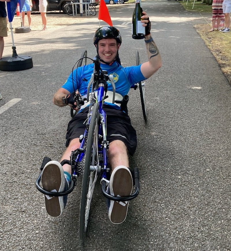 Finish line: former jockey Jacob Pritchard Webb celebrates as he completes his 140-mile charity hand cycle challenge. Photo: Beth McCabe