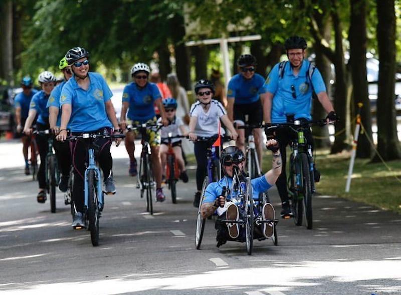 Not far to go: Jacob Pritchard Webb and his support team approach the finish line after his three-day hand cycle challenge. Photo: Beth McCabe