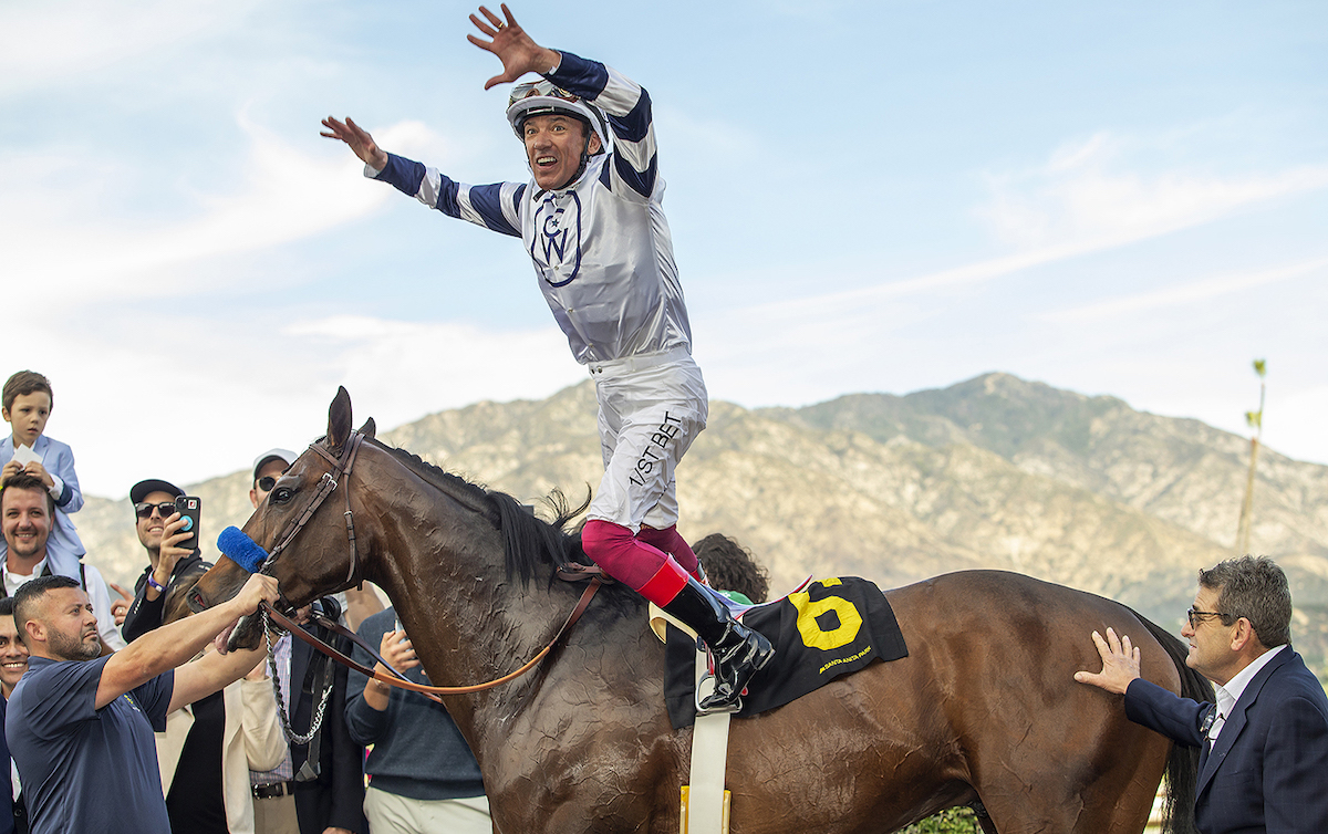 A treble and a flying dismount: Frankie Dettori performs his trademark leap from Country Grammer at Santa Anita. Photo: Benoit