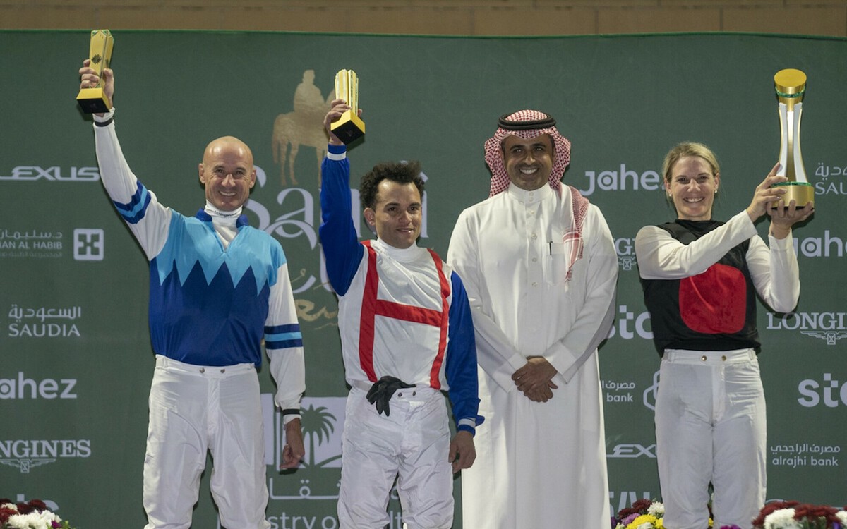 Caitlin Jones collects her 2022 IJC Trophy, alongside second-placed Glen Boss (left) and third-placed Joel Rosario (second left). Photo: Jockey Club of Saudi Arabia