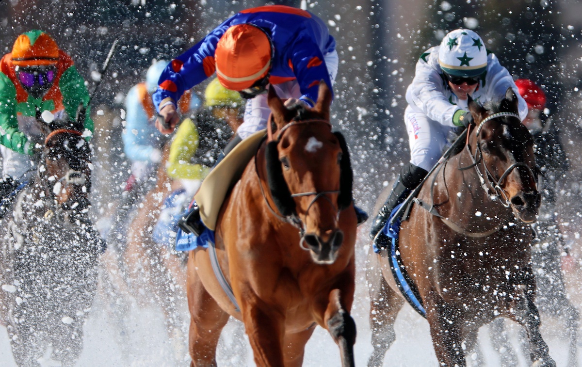 Stars in the snow: Moderator and jockey Clement Lheureux storm home in the feature event, the 83rd Grosser Preis von St Moritz. Photo: swiss-image / AndyMettler