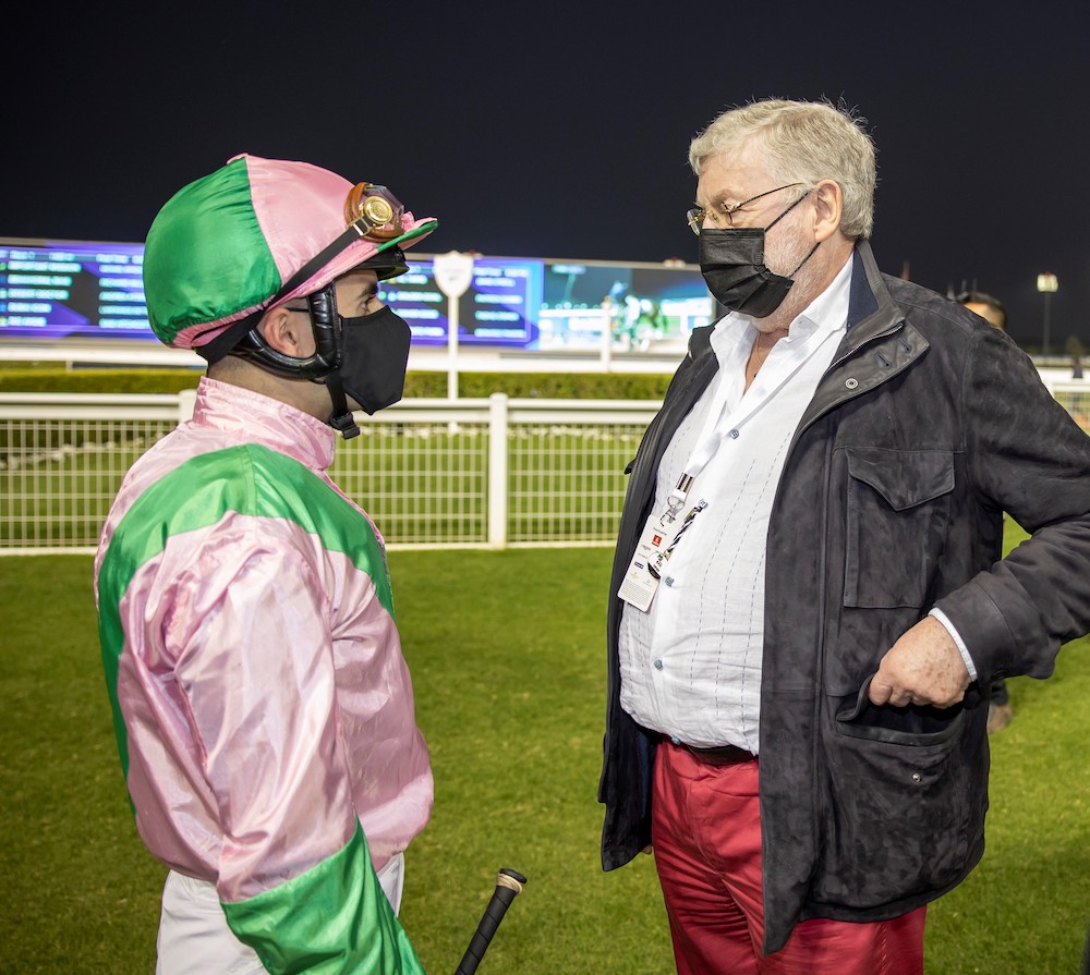 Talking tactics: Jim Hay with jockey Andrea Atzeni in his wife Fitri's silks at Meydan. Photo: Dubai Racing Club