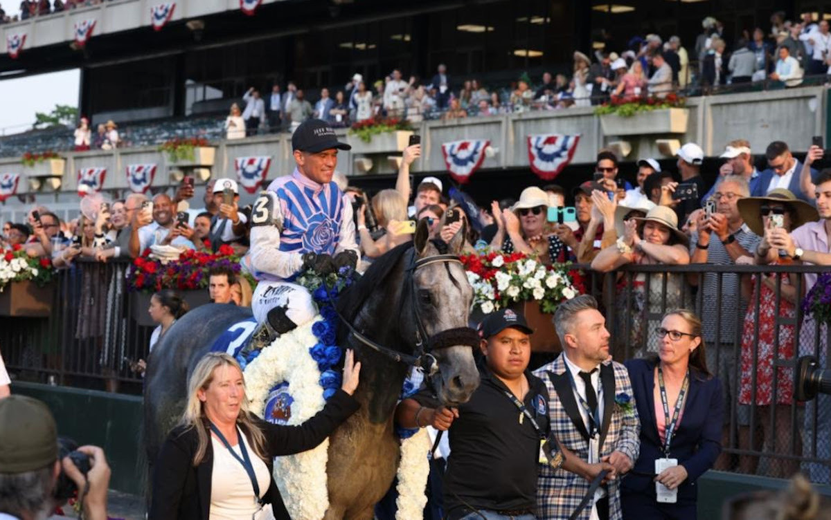 The conquering hero returns: Jena Antonucci (far right) as Arcangelo is lead in after the Belmont. Photo: Susie Raisher (Coglianese/NYRA)