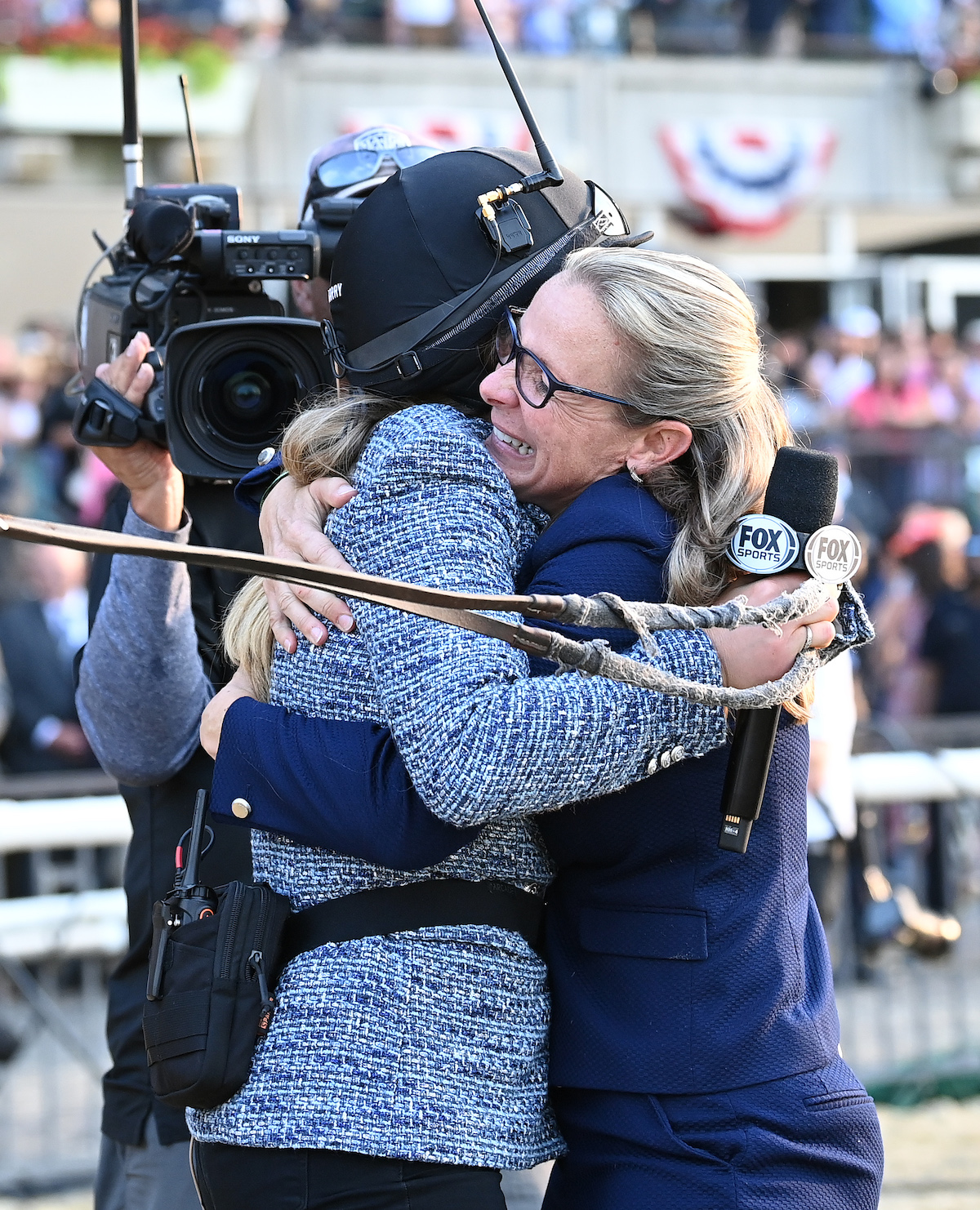 Time for a hug: Jena Antonucci embraces NYRA analyst Maggie Wolfendale after the Belmont. Photo: Susie Raisher (Coglianese/NYRA)