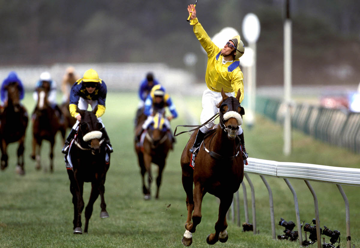 Damien Oliver partners Media Puzzle to an emotional success in the 2002 Melbourne Cup. Photo: VRC / Brett Stanley (Sport the library)