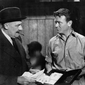 Uncle Oscar (Ronald Squire) confronts handyman Bassett (John Mills) over Paul's racetrack winnings. (Two Cities Films photo)