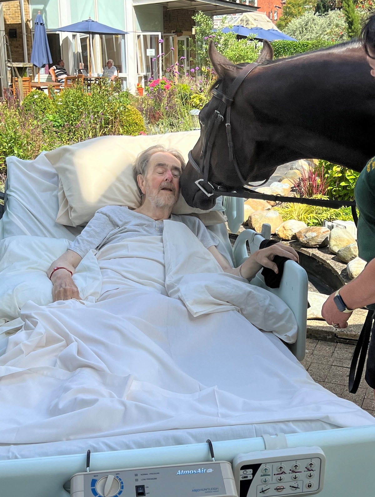 Andrew, an in-patient at St Gemma’s, said the visit by Remy made his day. Photo: St Gemma’s Hospice