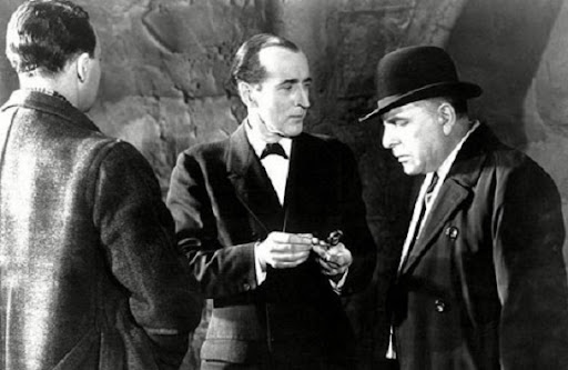 Arthur Wontner as Holmes shares an observation with John Turnbull's baffled Inspector Lestrade in the 1937 version of Silver Blaze. (Astor Pictures photo)