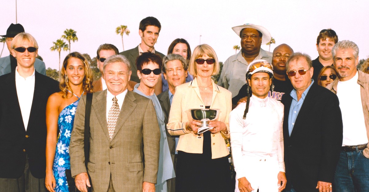 The Kona Gold clan in victory: Irwin Molasky (brown suit), Bruce Headley (next to Alex Solis), Aase Headley (the trainer's wife, holding the cup), behind her Andrew Molasky, and Gus Headley (far left). Photo: Benoit