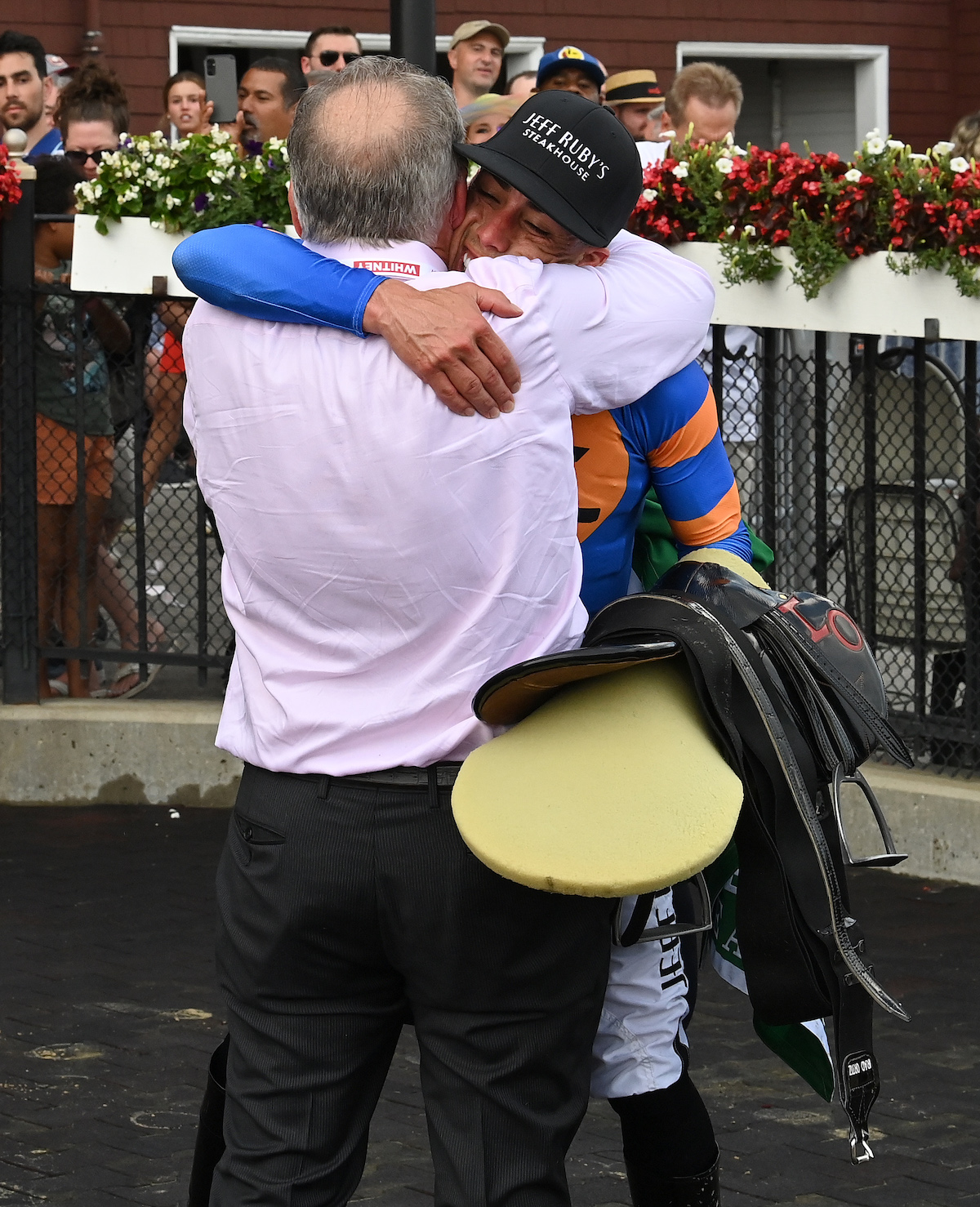 Back in the big time: Rick Dutrow embraces jockey Irad Ortiz after White Abarrio’s Whitney victory. Photo: NYRA/Susie Raisher