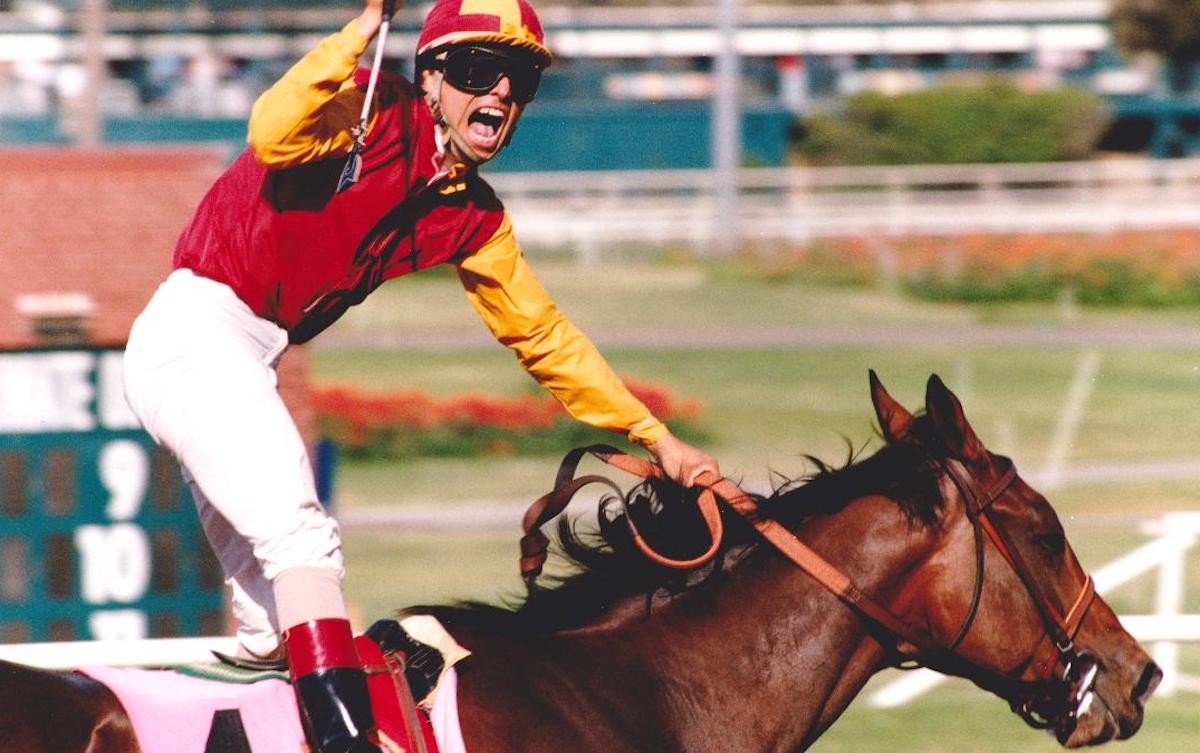 Pat Valenzuela salutes the crowd as Best Pal streaks to victory in the 1991 Swaps Stakes. Photo: Stidham & Assoc. / Hollywood Park*