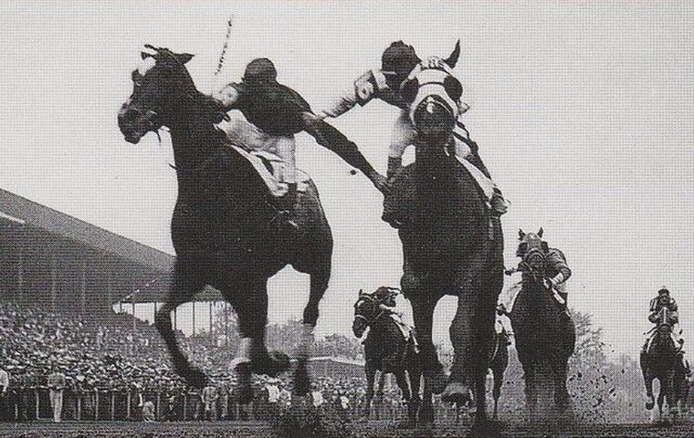 Wallace Lowry’s shot, published in the Louisville Courier-Journal, clearly shows the two jockeys flailing away at each other in the closing stages of the 1933 Run for the Roses
