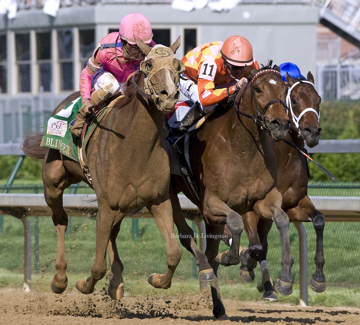 Mud-splattered Blind Luck is up in time to catch tenacious Evening Jewel in the Kentucky Oaks (Barbara Livingston photo)
