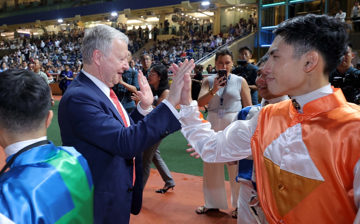 HKJC chief executive Winfried Engelbrecht-Bresges celebrates with jockeys at Happy Valley. Photo: HKJC